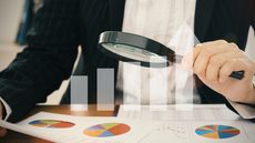 #pratodosverem: Imagem mostra pessoa visualizando conteúdo em uma folha de papel com o auxílio de uma lupa.